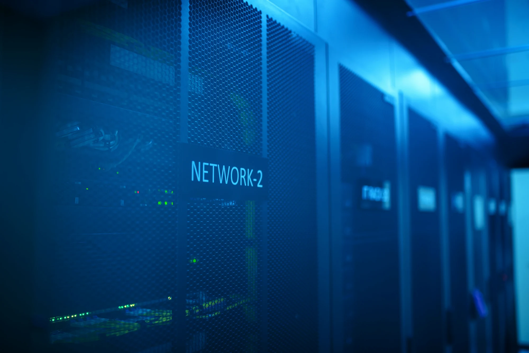 Blue-lit network server infrastructure representing a support platform