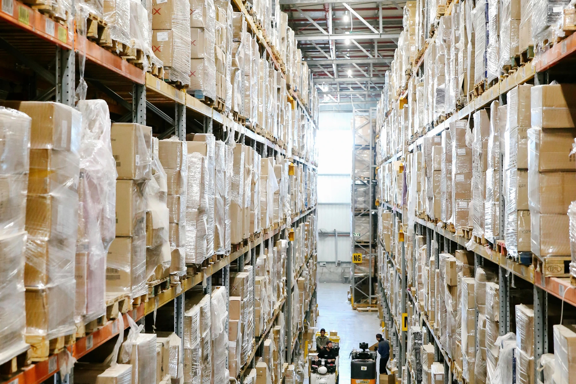 Real warehouse aisle with stocked shelves representing inventory and logistics operations