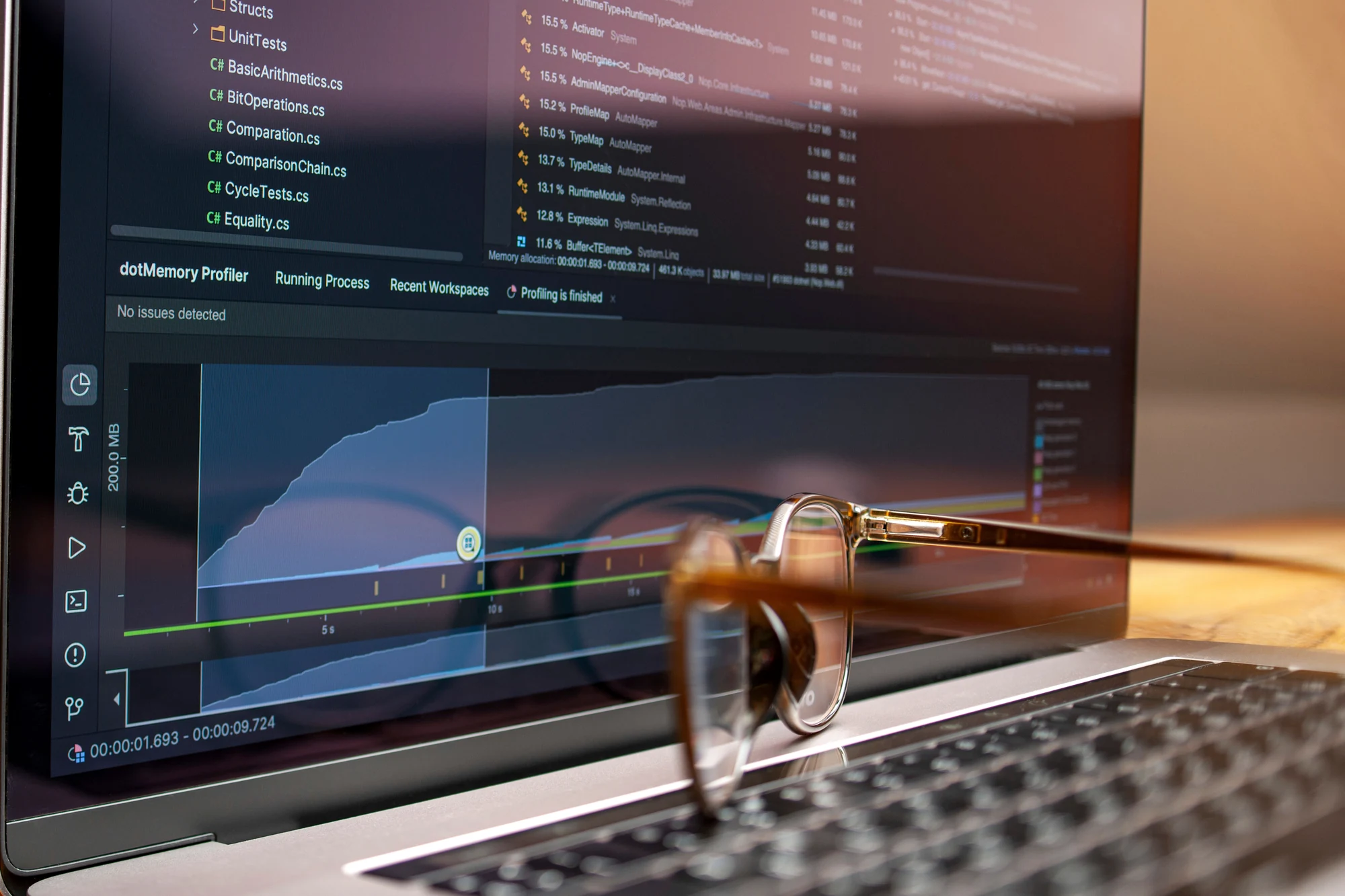 Laptop screen with code and performance graphs representing analytics engineering